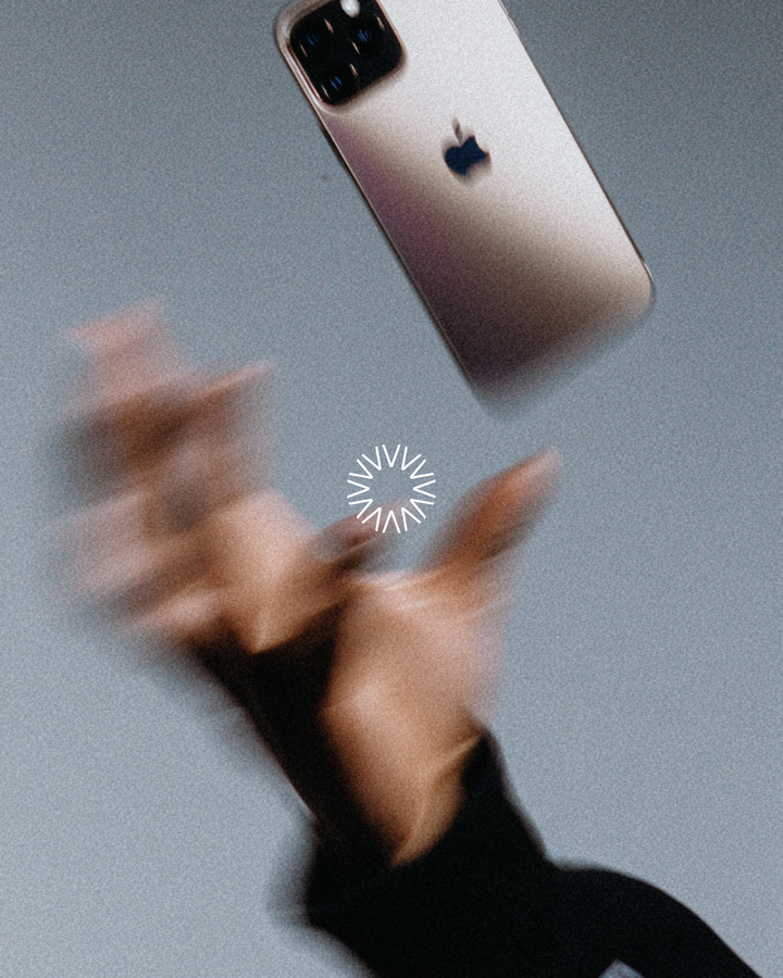 Vysionary brand image: hands reaching for a phone, motion blurred, with the Vysionary mark