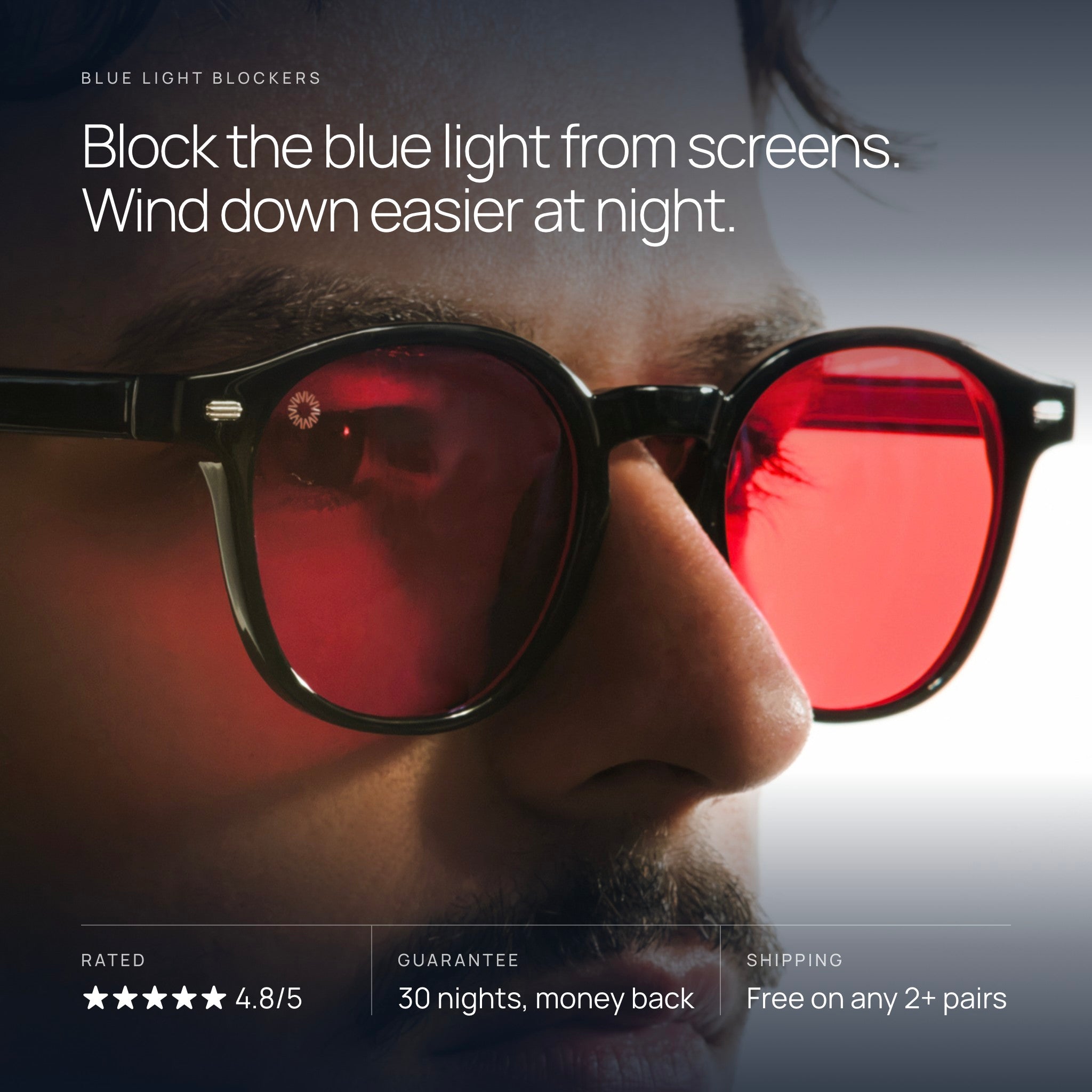 Man wearing Vysionary red lens Blue Light Blockers. Block the blue light from screens. Wind down easier at night. Rated 4.8 out of 5. Guarantee: 30 nights, money back. Free shipping on any 2+ pairs.