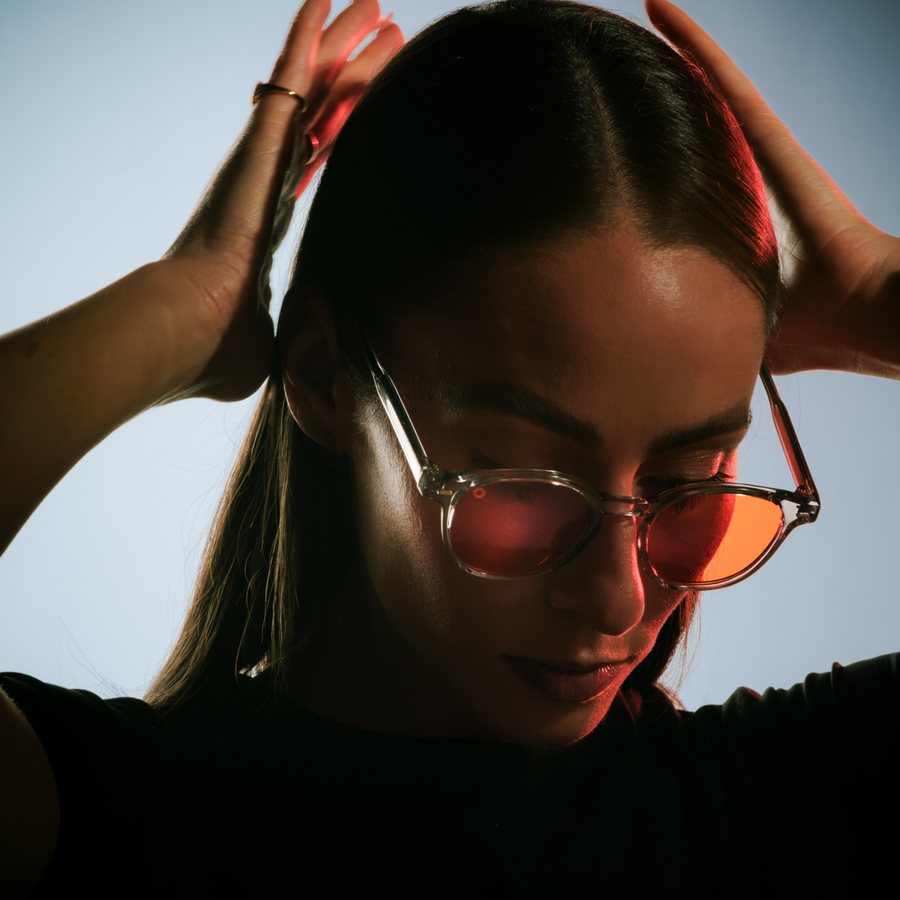 Woman wearing orange lens glasses